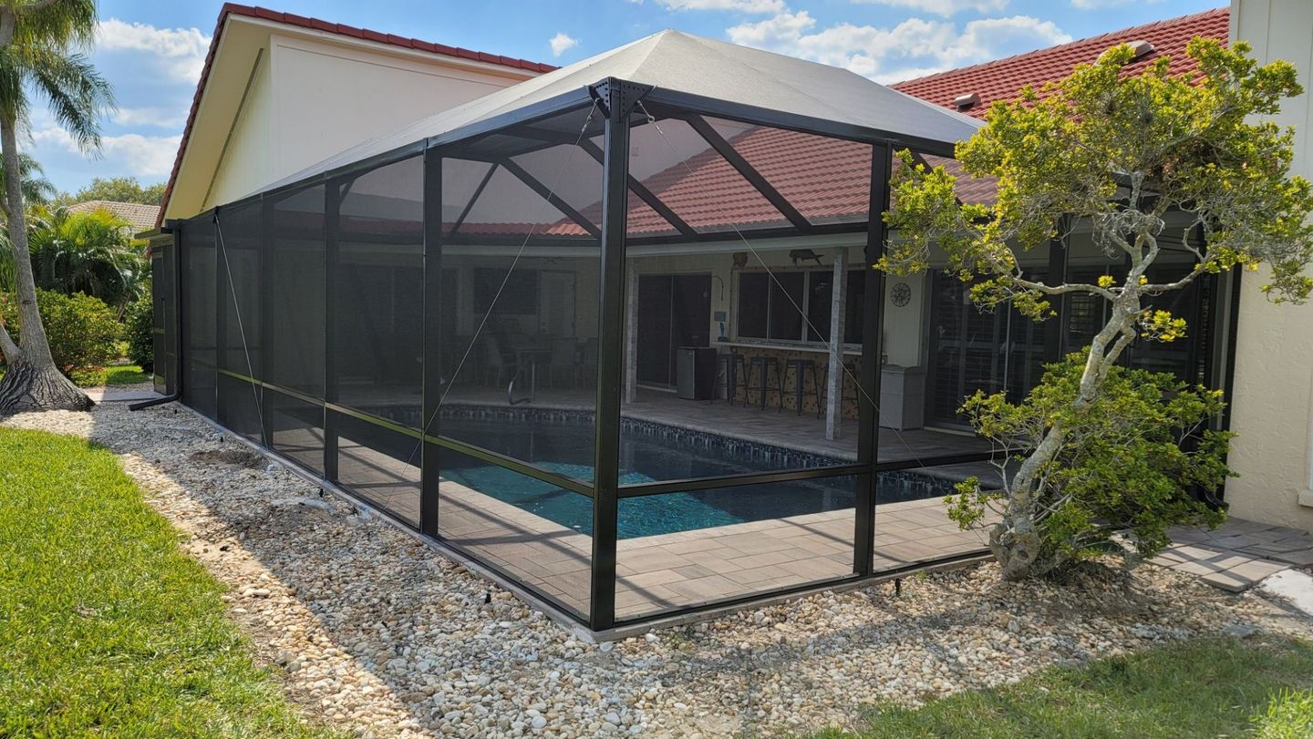 Modern front entry enclosure with custom screen detailing and glass panel doors